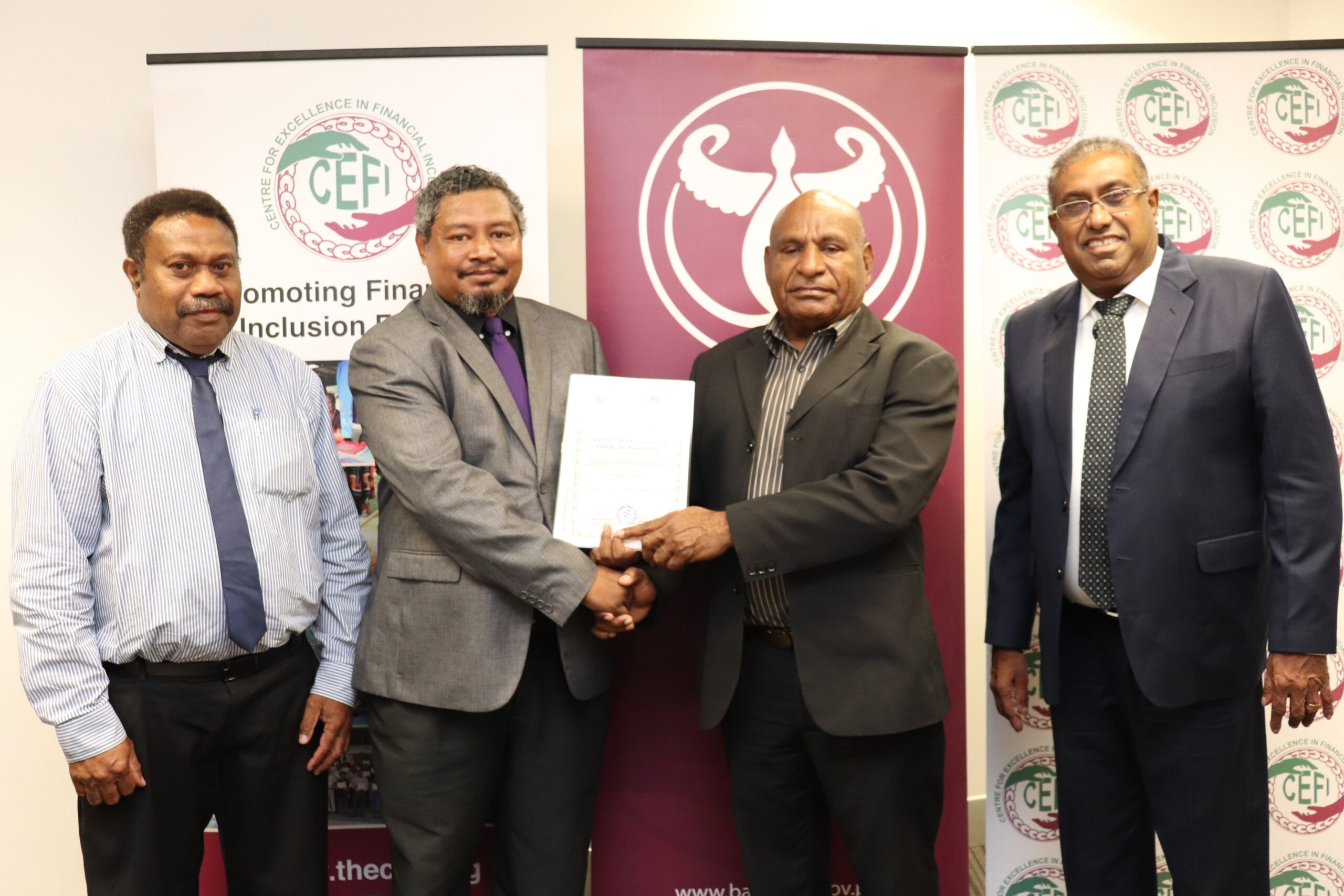 NTC Director Kinsella Geoffrey (2nd left) presenting the certificates to Acting Assistant Governor, Financial System Stability Group (FSSG), Bank of Papua New Guinea, George Awap witnessed by NTC Assistant Director Kevin Kalis (far left) and CEFI Executive Director Saliya Ranasinghe.
